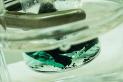 A solution turns green as it pulls cobalt from a spent lithium-ion cathode. A Rice University laboratory is developing an environmentally friendly method to recover valuable metals from used batteries. (Photo by Jeff Fitlow/Rice University)