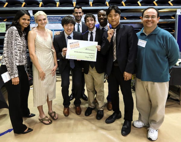 Drill Team Six won the top prize in the Brown School of Engineering Design Showcase. From left, adviser and bioengineering lecturer Sabia Abidi, Hannah Jackson, Takanori Iida, Will Yarinsky, Ian Frankel, Babs Ogunbanwo, Byung-UK Kang and Matthew Elliott, a lecturer in mechanical engineering. Photo by An Le/Luxe Studio Productions
