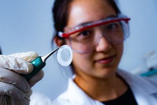 Rice University graduate student Natsumi Komatsu holding a piece of filter membrane paper on which a carbon nanotube film has formed.
